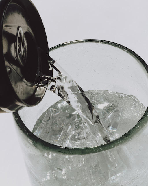 A close-up of some seltzer being poured into a glass